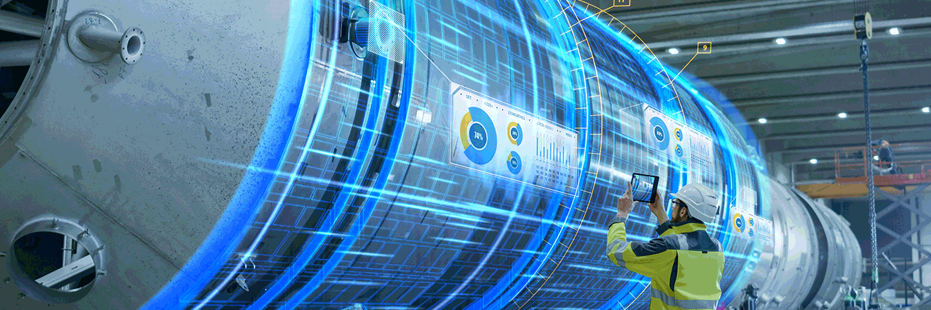 Ein Mann aus der Maschinenfertigung steht mit einem Tablet vor einem großen Maschinenteil und nutzt die Möglichkeiten von Augmented Reality.